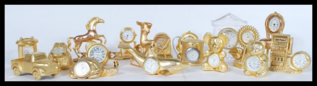 A collection of yellow metal and brass miniature novelty clocks to include a clock in the form of