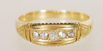 An 18ct gold 5 stone diamond ring, the stones being channel set within gypsy setting, diamonds