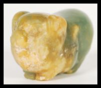 A 19th Century carved Chinese jade toggle or pendant in the form of a pig. Hole to body for string