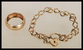 A hallmarked 9ct gold heart lock bracelet along with an unmarked 9ct gold band ring (tests as 9ct