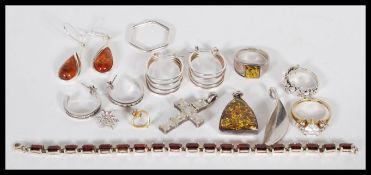 A selection of silver jewellery to include a pair of hooped earrings channel set with white