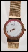 A ladies decorative yellow stainless steel Skagen - Denmark dress watch. Having a mother of pearl