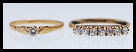 A hallmarked 9ct gold ring set with seven white stones (hallmarked Birmingham, size Q) along with