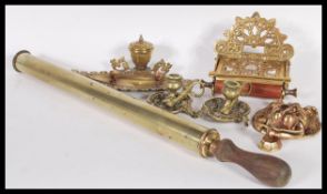 A collection of brass wares dating from the 19th Century to include an Art Nouveau toilet roll