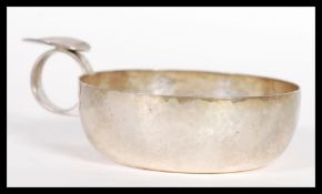 A silver hallmarked handled wine tasting cup having a hammered finish. Hallmarked Edinburgh.
