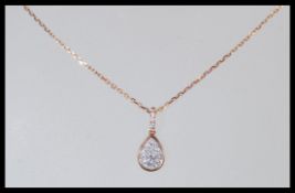 An 18ct rose gold and diamond cluster pendant and necklace set having approx 20pts of diamonds.