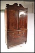 A 19th Century Regency mahogany linen press raised on a two over two chest base with twin cupboard