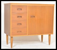 A vintage retro 20th Century teak sewing cabinet of good proportions having configuration of
