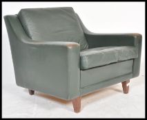 A vintage retro 20th Century Danish green leather armchair in the manner of Hurt Ostering. The chair