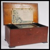 A 19th Century Victorian music box in a stained mahogany case , plays 10 airs, having three bells