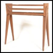 A retro 20th Century teak wood planter, raised on open shaped angular supports with slated front and