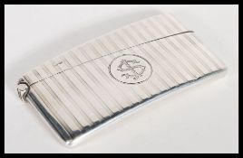 An early 20th Century Edwardian hallmarked silver card case of curved form by Hamilton & Co having