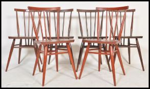 A set of six Ercol vintage 20th Century spindle back beech and elm dining chairs, solid seat pads