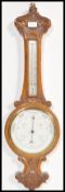 A vintage early 20th Century oak cased Aneroid Banjo barometer with carved detailing, white enamel