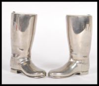 A pair of 20th Century silver plated drinks measures in the form of riding boots having raised