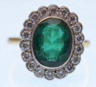 18CT GOLD EMERALD AND DIAMOND CLUSTER RING