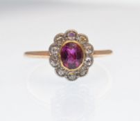 AN 18CT GOLD RUBY AND DIAMOND LADIED CLUSTER RING