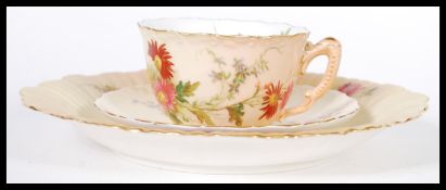 A Royal Worcester Ivory blush matched trio having chintz foliate pattern. The cup with puce mark