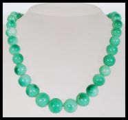 A vintage Chinese believed green jade or Peking gl