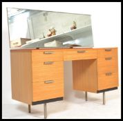 A vintage retro 20th century Stag twin pedestal kneehole dressing table having a twin bank of 3