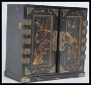A 19th Century Japanese black lacquer cabinet having gilt decoration depicting birds having ornate