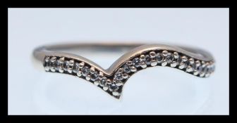 A hallmarked 9ct gold wish bone ring set with white stones. Hallmarked London 2006. Size Q.5.