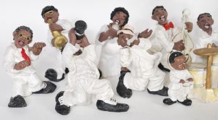 A collection of composite figures of negro jazz musicians to include singers and band members