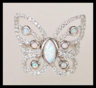 A sterling silver marcasite ring in the form of a butterfly having central opal panel. Weighs 6