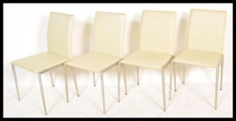 A set of 4 20th century modernist chrome and white faux leather dining chairs. Tubular chrome frames