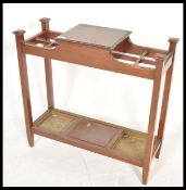 A 19th century mahogany stick stand in the manner of Shoolbred of London. Raised on squared legs