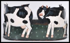 A vintage 20th Century folk art planter, upcycled from a Victorian tin hat tin. The tin cut out in