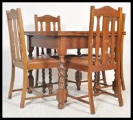 An early 20th Century Art Deco oak draw leaf dining table and set of four matching chairs, the table