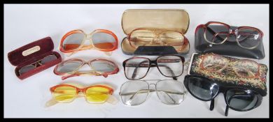A collection of vintage retro 20th Century sunglasses to include mostly examples with plastic