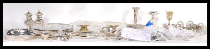 A collection of silver plated wares to include various a1 silver plate flatware, pepperettes, blue