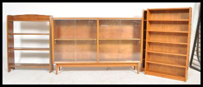 A retro 20th Century teak wood glazed bookcase, fitted with adjustable shelves to the interior,