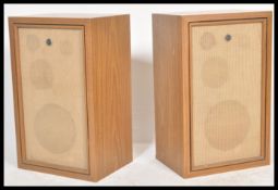A pair of vintage retro 20th Century teak wood cased Sanyo hi fi speakers in a wooden teak casing.