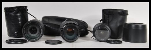 A collection of three Canon digital camera lenses to include a zoom lens EF70-300mm 1 : 4-5.6 1S