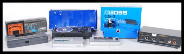A group of vintage electronic guitar tuners to include Yamaha, boxed Boss CS-3, other Boss examples,