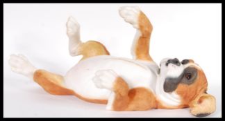 A Country Artist large resin figurine of a playful reclined boxer dog puppy entitled Puppy Love