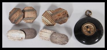 Two pairs of early 20th Century Art Deco cufflinks both having engine turned decoration. One of oval