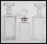 A group of three vintage 20th Century glass decanters to include a cut glass example with a pair