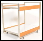 A retro mid 20th Century two tier drinks / buffet trolley. The trolley raised on a aluminum