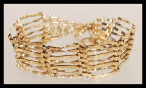 A hallmarked 9ct gold bar link bracelet chain having a heart padlock clasp. Hallmarked to the