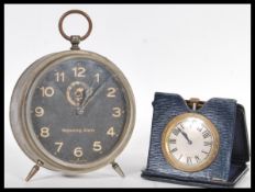 A vintage early 20th Century brass travel car pocket watch clock in folding leather case along
