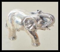 A sterling silver miniature figurine of an elephant. Weight 18.4g. Measures 2.5cm high.