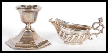 A 20th Century silver hallmarked candle stick holder having a hexagonal base (hallmarked