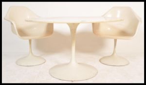 A vintage retro 20th century Arkana tulip dining table along with a pair of Marcel Burke matching