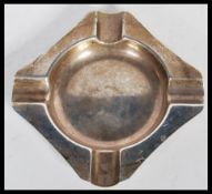 A silver hallmarked cigarette ashtray, of square form having a round bowl to the centre.