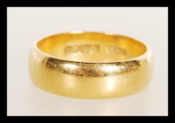 A 22ct gold gentleman's band ring being hallmarked. Size N, weight 6.8g