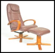 A contemporary leather swivel  chair with matching footstool, the chair and footstool upholstered in